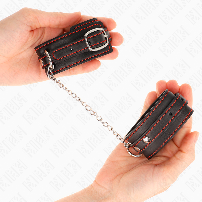 Small black wrist restraints with red lining adjustable 14-24 cm x 3.5 cm